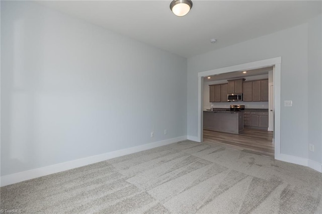 206 Cason Dr, Gibsonville, NC 27249 - unfurnished living room featuring light carpet and baseboards