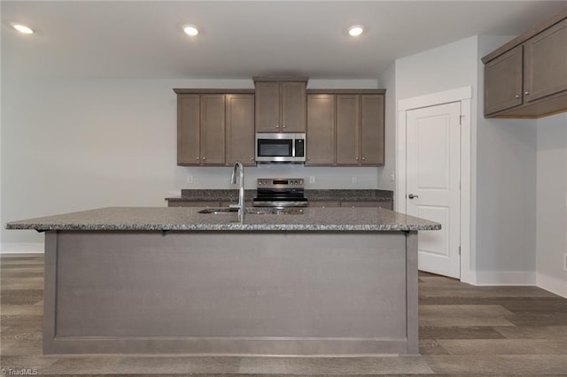 206 Cason Dr, Gibsonville, NC 27249 - kitchen featuring stainless steel appliances, baseboards, dark wood finished floors, stone counters, and recessed lighting