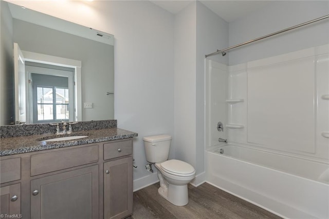 206 Cason Dr, Gibsonville, NC 27249 - full bath with wood finished floors, toilet, baseboards, vanity, and washtub / shower combination