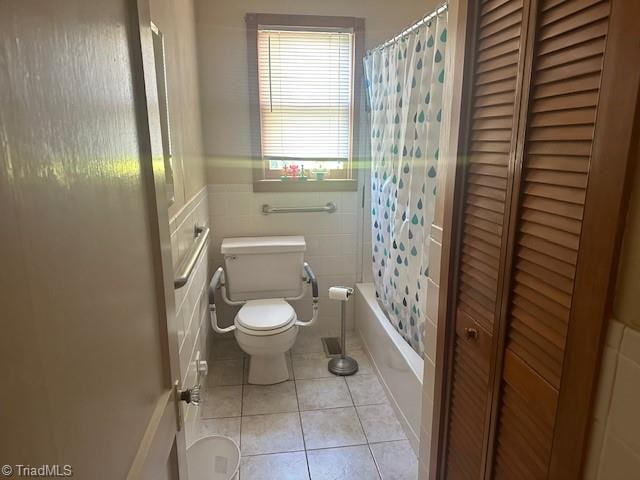 bathroom featuring tile walls, tile patterned flooring, shower / tub combo, and toilet