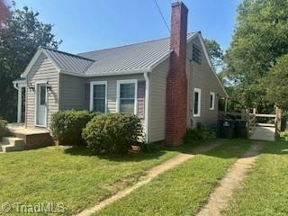 view of property exterior with a yard