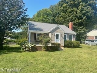 bungalow-style home featuring a front lawn