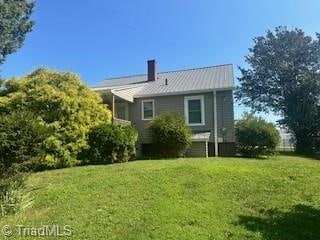 rear view of house with a lawn