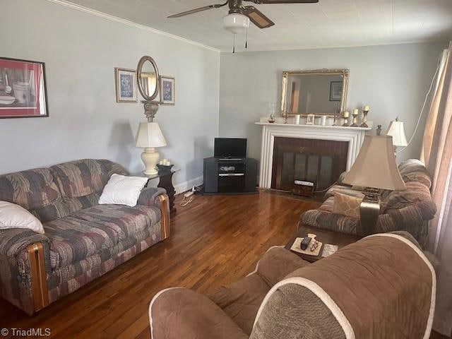 living room featuring ceiling fan, crown molding, and dark hardwood / wood-style flooring