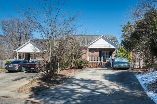 view of front facade featuring concrete driveway, a porch, and brick siding