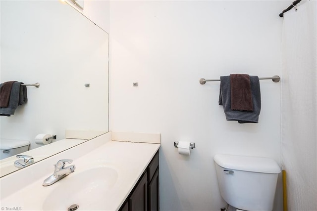 full bathroom with toilet and vanity