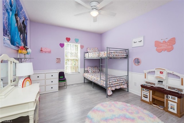 bedroom featuring ceiling fan, baseboards, and wood finished floors