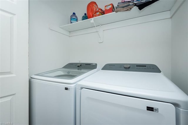 clothes washing area featuring washing machine and clothes dryer