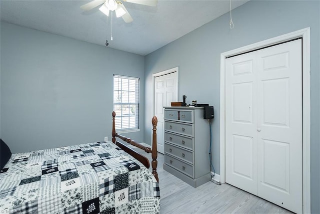 bedroom featuring multiple closets, light wood-style floors, baseboards, and a ceiling fan