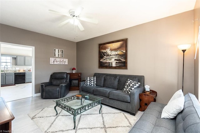 living room with light wood-style floors and a ceiling fan