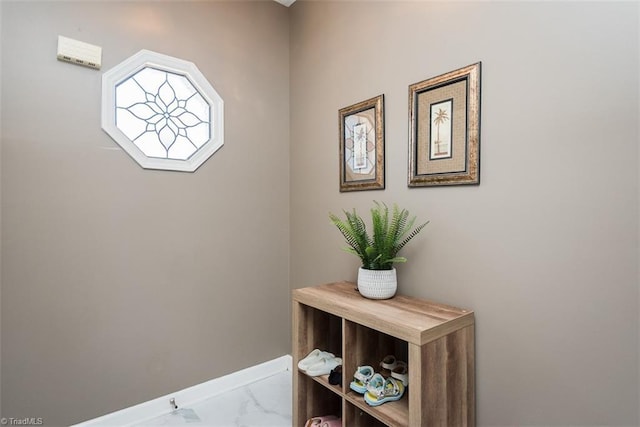 interior space with marble finish floor and baseboards