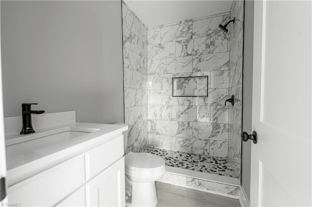 300 Center St, Thomasville, NC 27360 - bathroom featuring toilet, tiled shower, and vanity