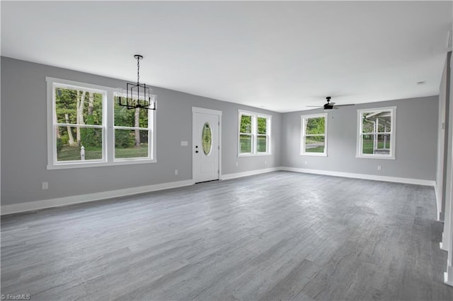 300 Center St, Thomasville, NC 27360 - unfurnished living room with a chandelier, ceiling fan, wood finished floors, and baseboards