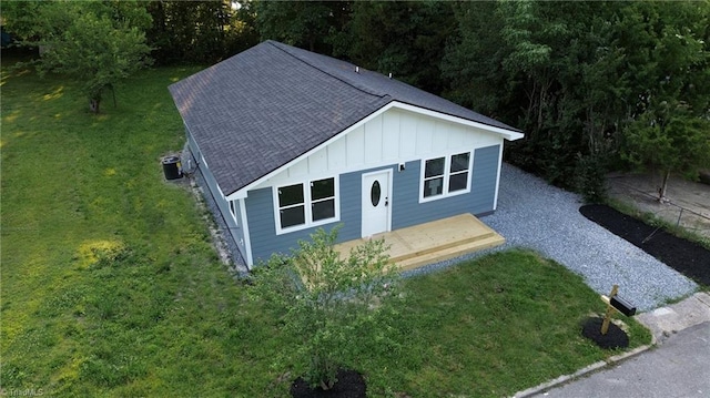300 Center St, Thomasville, NC 27360 - view of front facade featuring board and batten siding, a shingled roof, a front yard, and central air condition unit