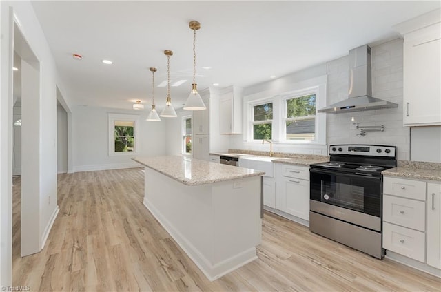 304 Louise Ave, High Point, NC 27262 - kitchen featuring stainless steel appliances, wall chimney exhaust hood, a kitchen island, healthy amount of natural light, and recessed lighting