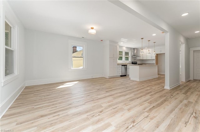 304 Louise Ave, High Point, NC 27262 - unfurnished living room featuring healthy amount of natural light, light wood-style floors, recessed lighting, and baseboards