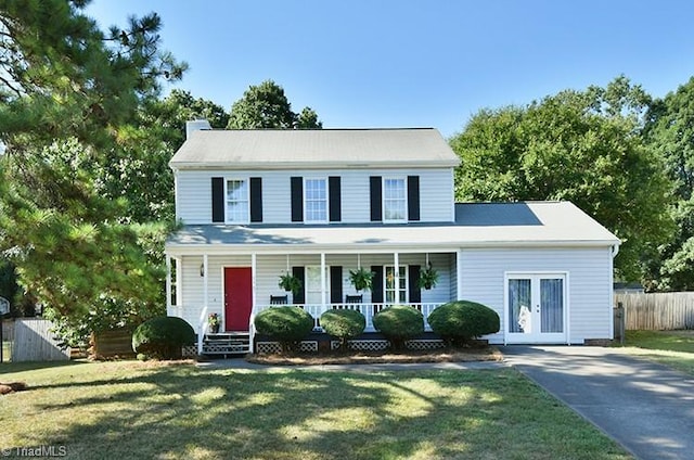 colonial home featuring a porch and a front lawn