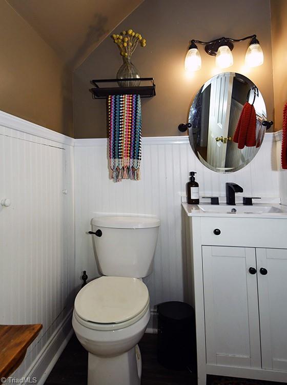5467 Moravian Heights Ln, Clemmons, NC 27012 - bathroom featuring wainscoting, vanity, and wood finished floors