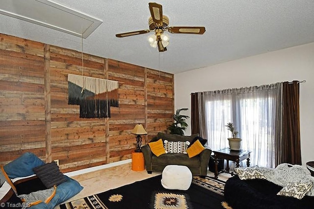 5467 Moravian Heights Ln, Clemmons, NC 27012 - living room featuring attic access, wooden walls, ceiling fan, and a textured ceiling