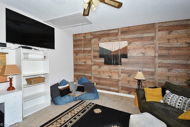 5467 Moravian Heights Ln, Clemmons, NC 27012 - living area with attic access, wood walls, a ceiling fan, and a textured ceiling