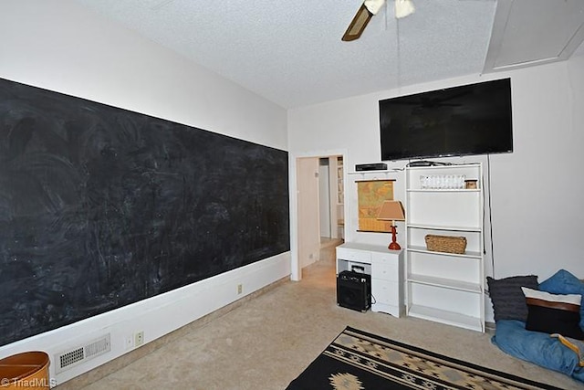 interior space featuring a textured ceiling and ceiling fan