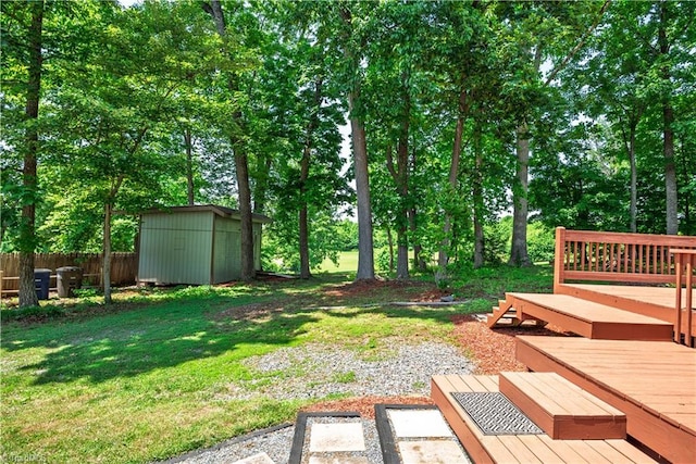 1625 Eagle Crest Dr, Pfafftown, NC 27040 - view of yard featuring a storage unit, a deck, an outbuilding, and view of scattered trees