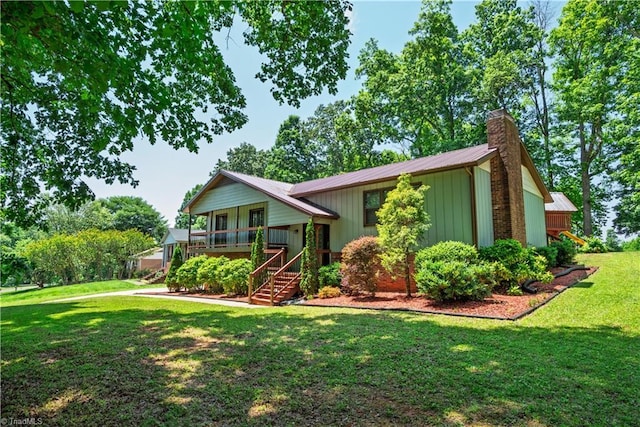 1625 Eagle Crest Dr, Pfafftown, NC 27040 - view of front of property featuring stairway, a chimney, a front yard, a porch, and metal roof
