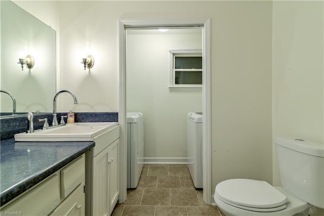 1625 Eagle Crest Dr, Pfafftown, NC 27040 - bathroom featuring toilet, separate washer and dryer, vanity, baseboards, and stone finish flooring