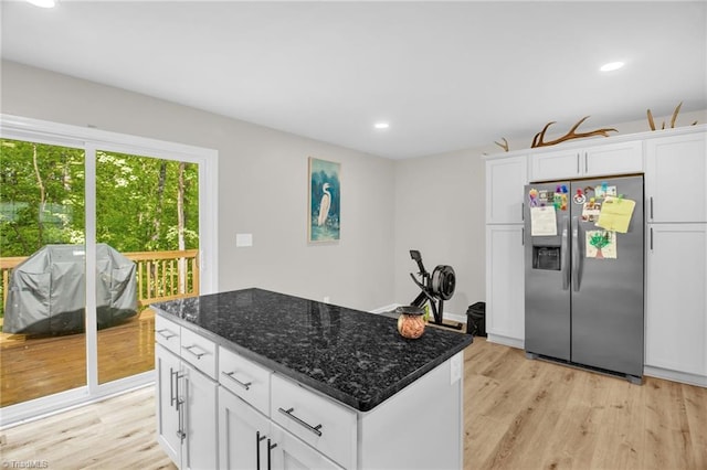 kitchen with a kitchen island, recessed lighting, stainless steel fridge, and light wood-style floors