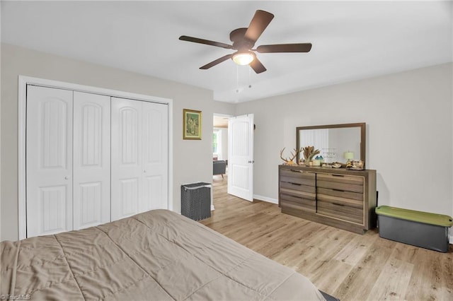 bedroom featuring a closet, a ceiling fan, baseboards, and wood finished floors