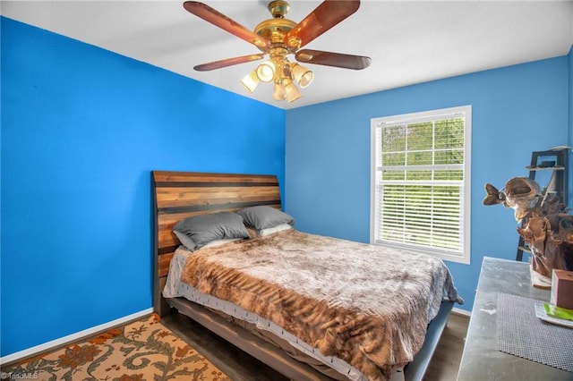 bedroom featuring baseboards and ceiling fan