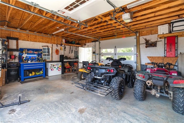 garage featuring a garage door opener and a workshop area
