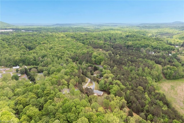 aerial view featuring a wooded view