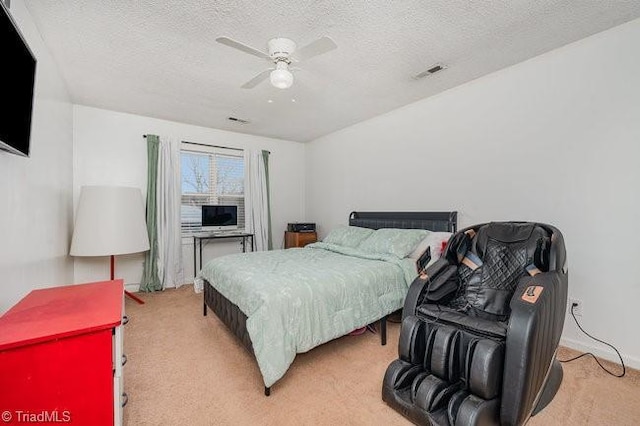 carpeted bedroom featuring a textured ceiling and ceiling fan