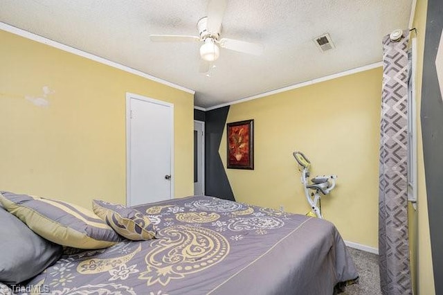 bedroom featuring a textured ceiling, ceiling fan, carpet floors, and crown molding