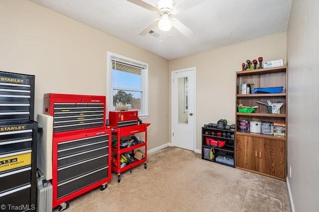 miscellaneous room with a textured ceiling, ceiling fan, and light carpet