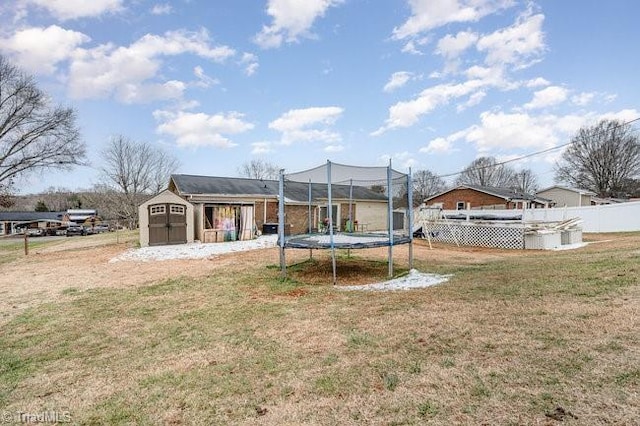 view of yard featuring a shed and a trampoline