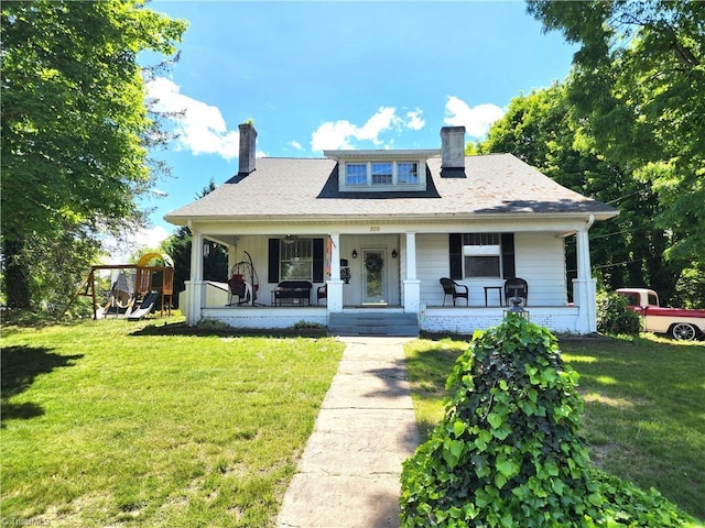 bungalow-style house with a chimney, a front lawn, and a porch