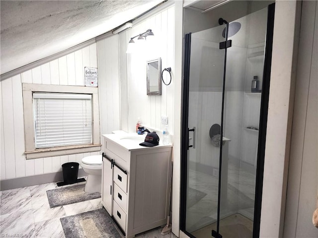full bath with a stall shower, vanity, and toilet