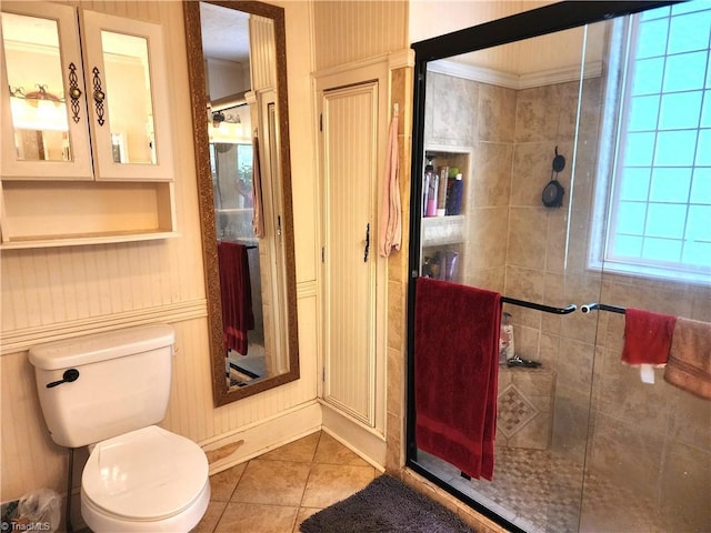 full bathroom featuring a stall shower, toilet, and tile patterned flooring