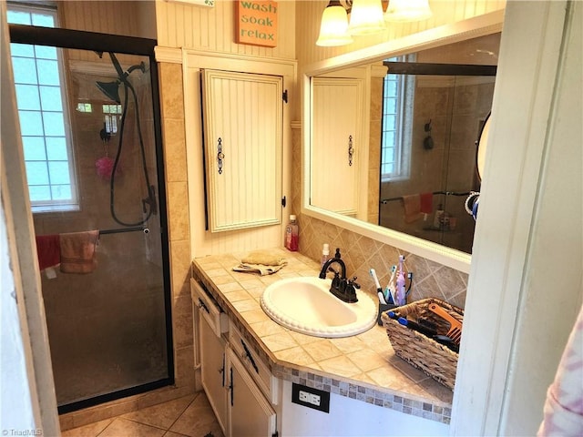 bathroom featuring a shower stall, vanity, decorative backsplash, and tile patterned floors