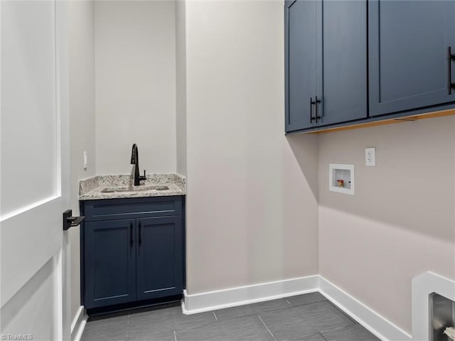 laundry room featuring cabinets, washer hookup, and sink