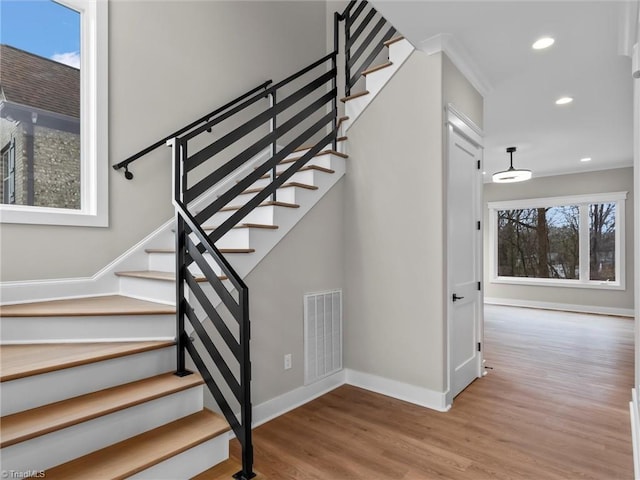 stairs featuring hardwood / wood-style floors