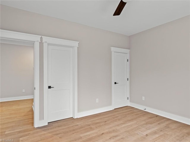 unfurnished bedroom featuring ceiling fan and light wood-type flooring