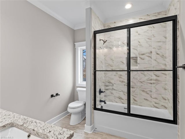 bathroom featuring crown molding, wood-type flooring, toilet, and combined bath / shower with glass door