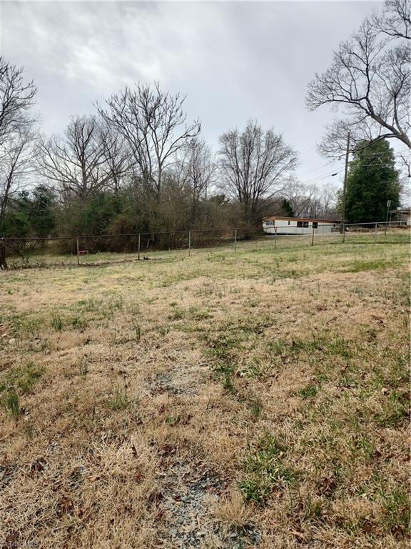 view of yard featuring fence and a rural view