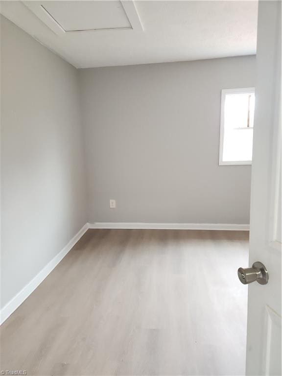 unfurnished room featuring wood finished floors and baseboards