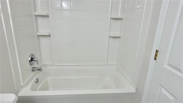 bathroom featuring toilet and shower / tub combination