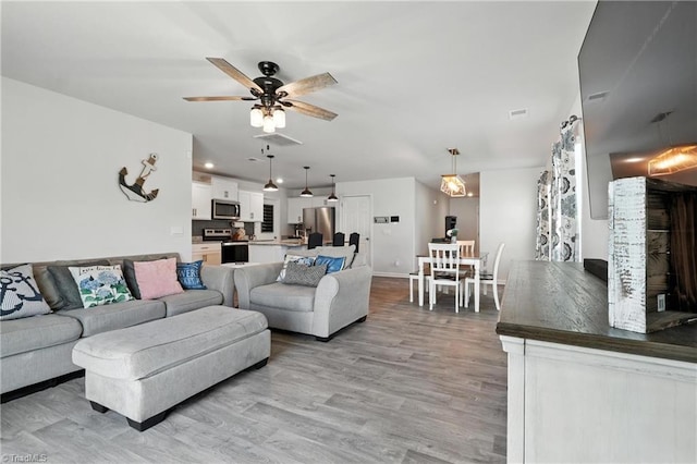 4514 Heatherly Rd, Winston-Salem, NC 27105 - living area featuring light wood-type flooring and ceiling fan