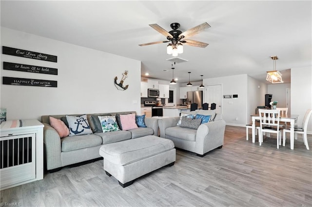4514 Heatherly Rd, Winston-Salem, NC 27105 - living area with light wood-style floors and a ceiling fan